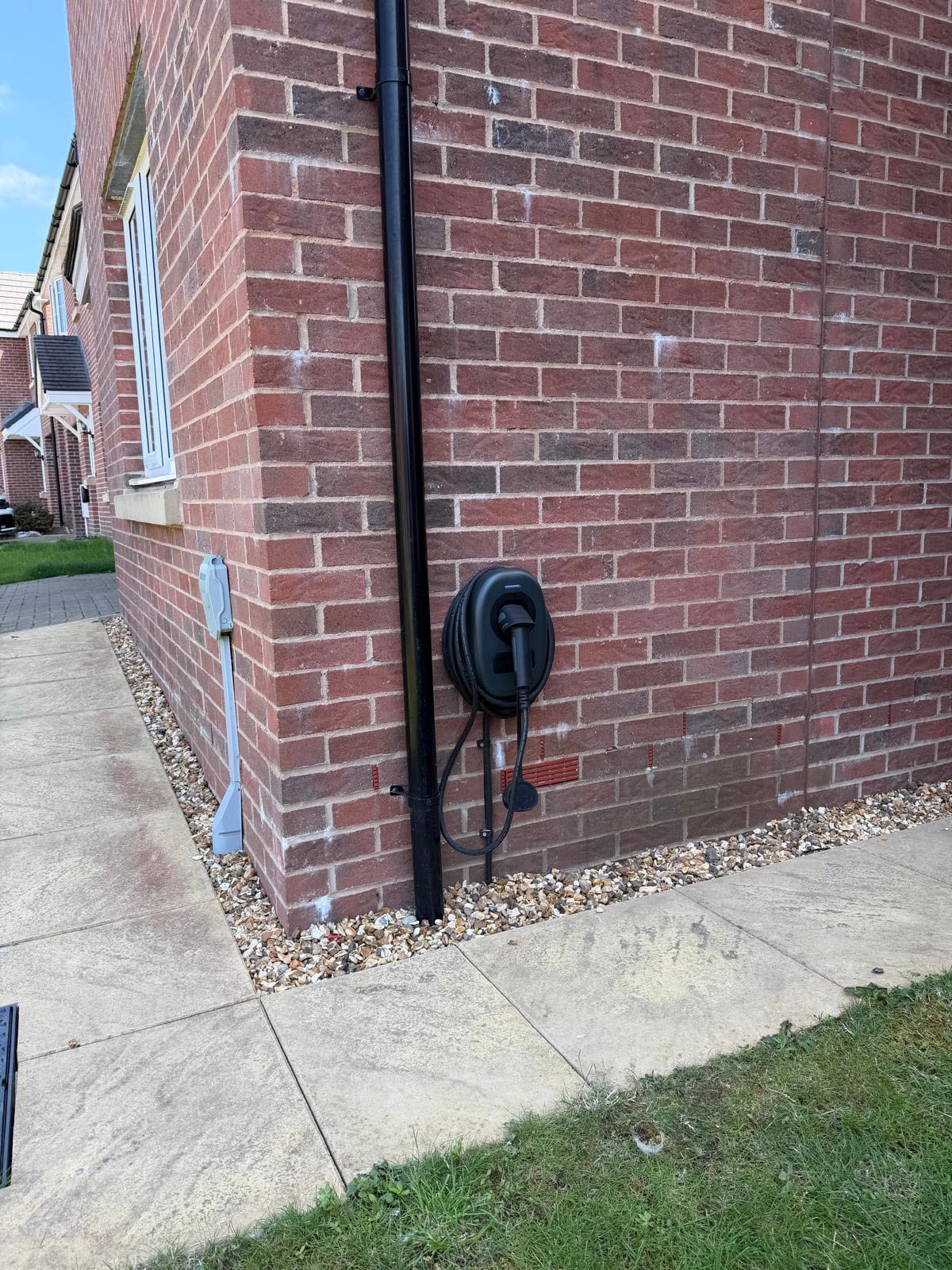 An EV charger fitted to the side wall of a new-build house by RM Electrical