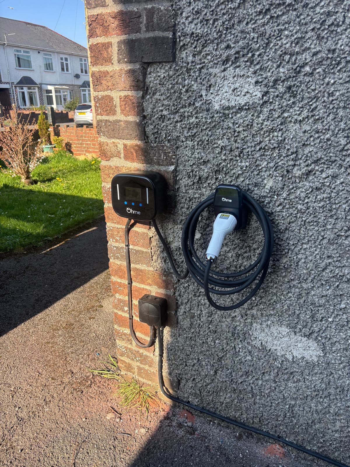 Two Ohme EV chargers fitted side by side on a house wall