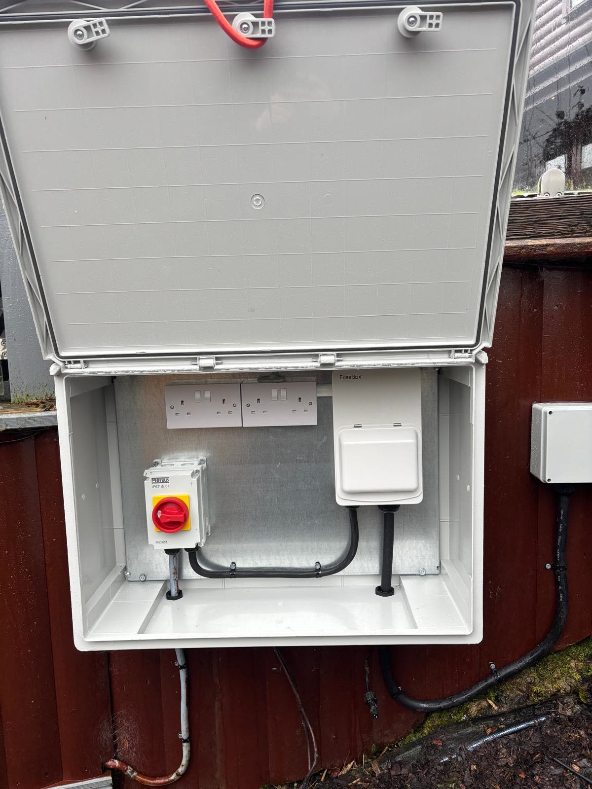 A weatherproof outdoor enclosure with sockets and an isolator